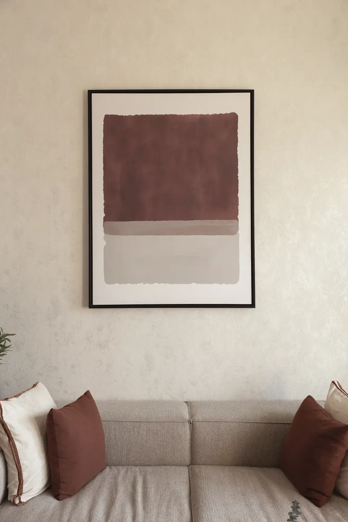 Living room corner with abstract terracotta wall art above a linen sofa. Interior design photography for Aziza Home by MRPS in Dubai.