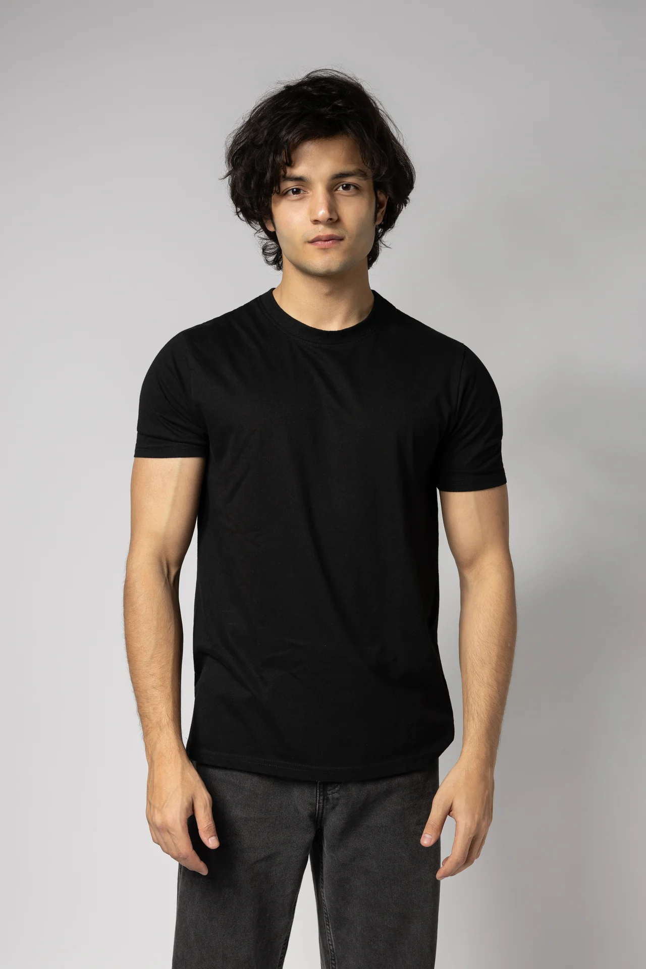 Front-facing half-length digital of Arsh in a plain black t-shirt, a clean modeling portfolio shot taken in Dubai.