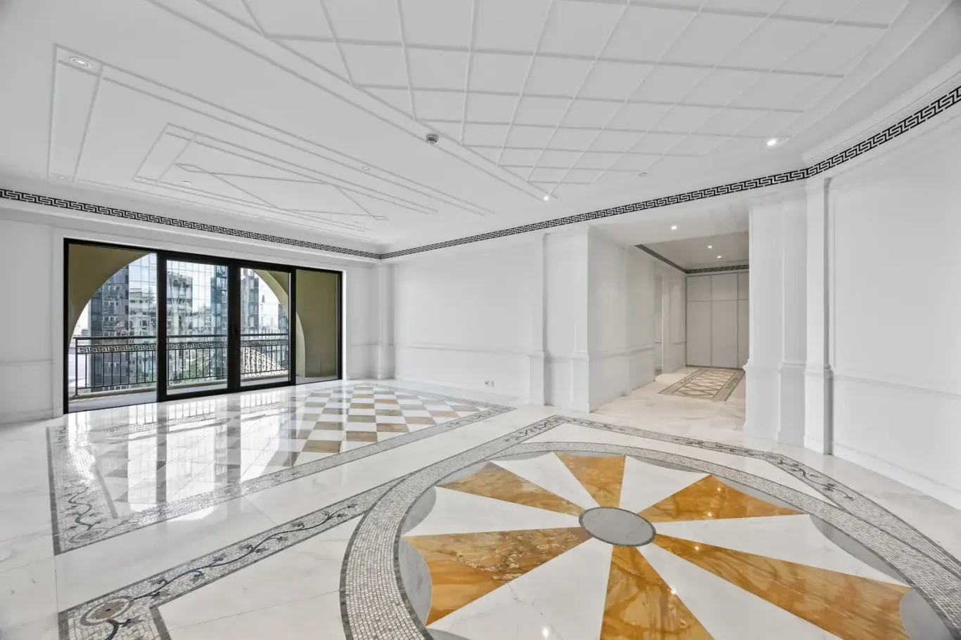 Reception with an inlaid marble medallion floor and creek-facing windows in a three-bedroom residence at Palazzo Versace Dubai, Jaddaf Waterfront, photographed for Concierge Auctions.