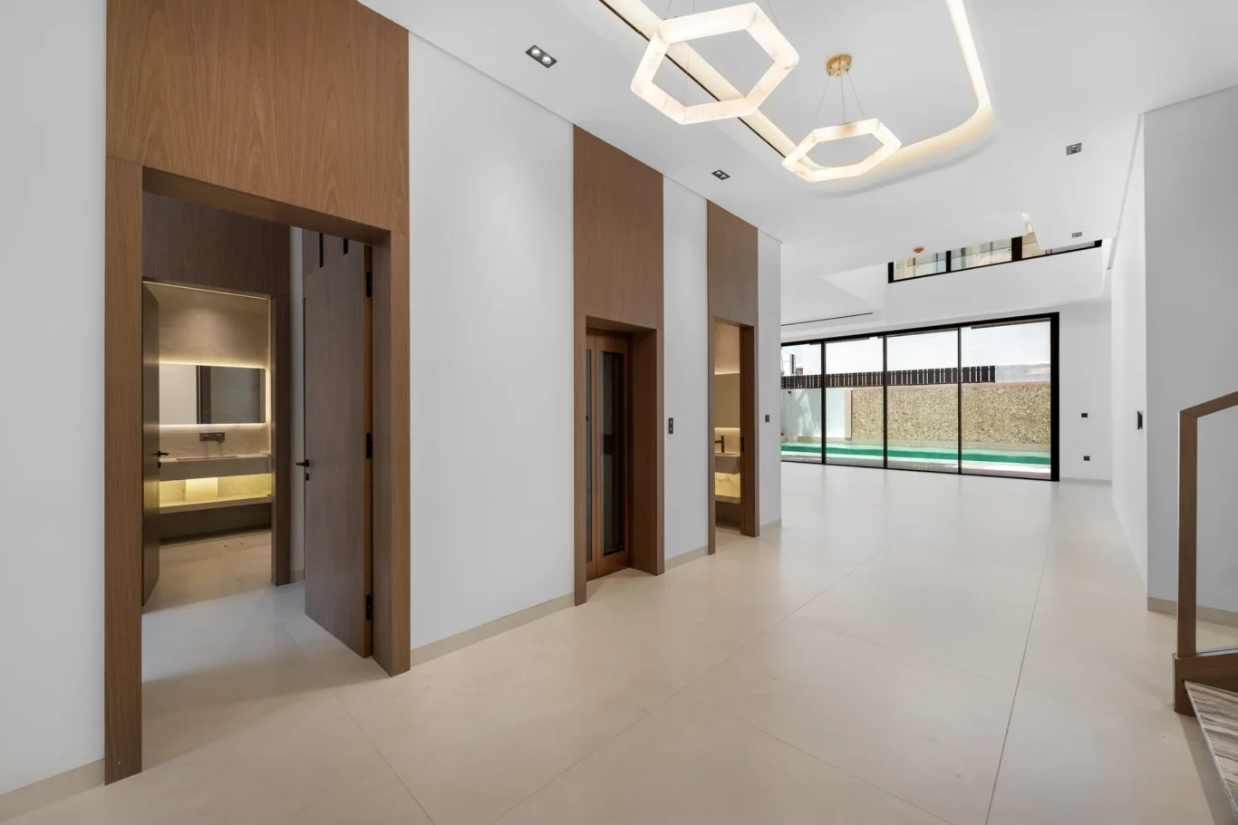 Hallway looking through to the living area and pool, unfurnished five-bedroom villa in Al Furjan, Dubai.