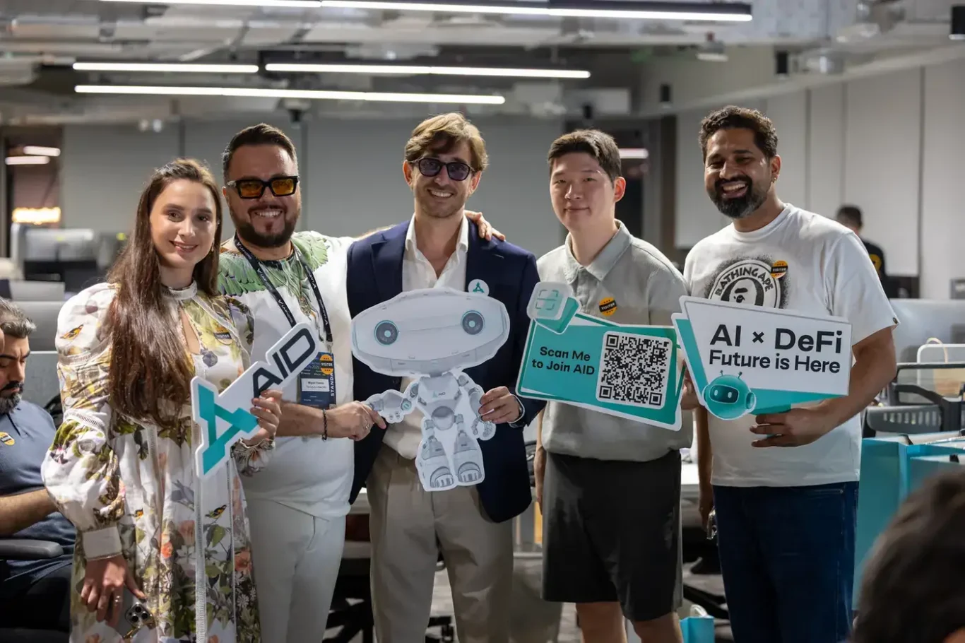AID team and guests with branded signs and the mascot. Event photography by MRPS at Blockchain Life 2025, Festival Arena, Dubai.