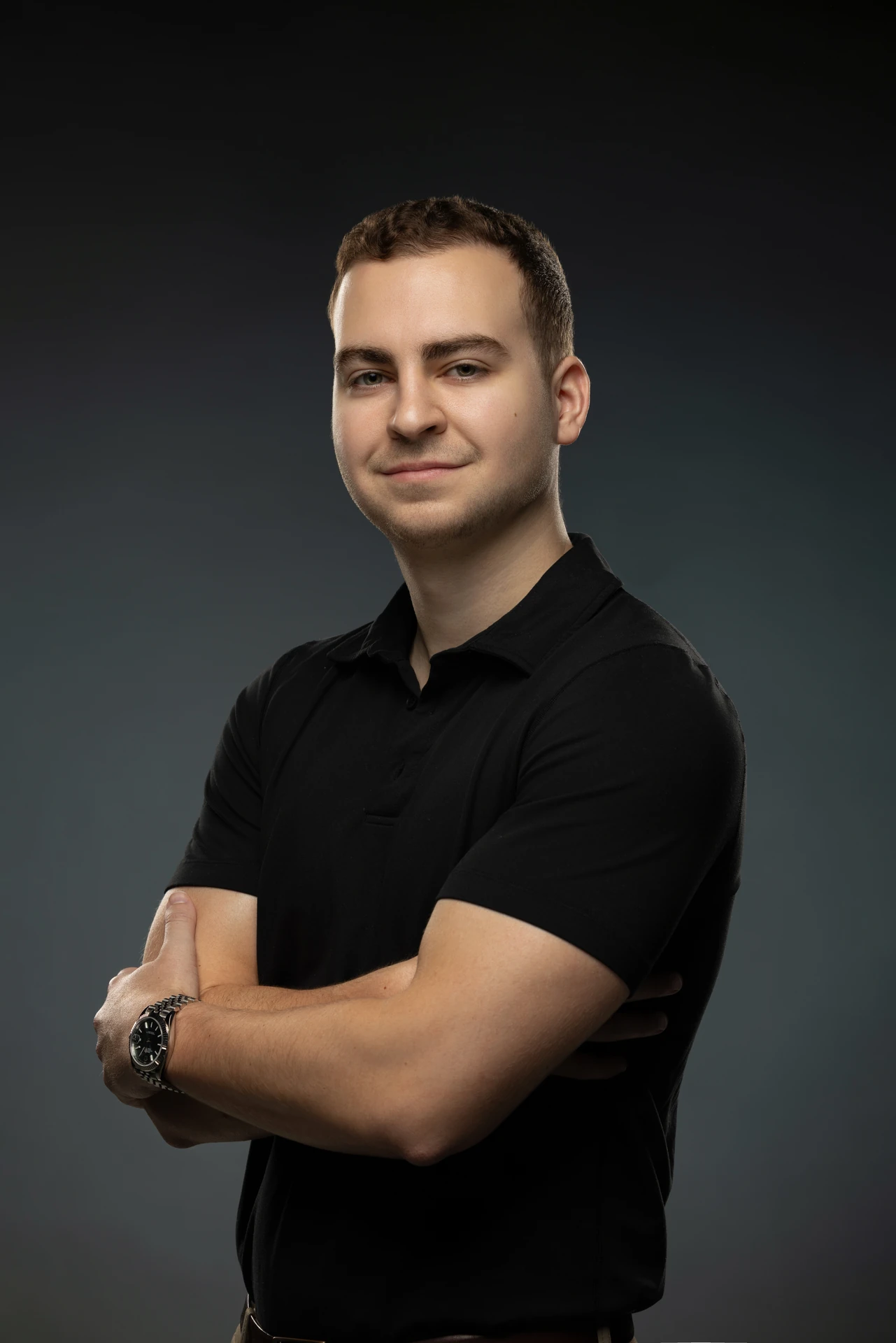 Arms crossed portrait in a black polo shirt. Professional headshot of Tim Ruscica of Tech With Tim, photographed at the MRPS studio in Dubai.