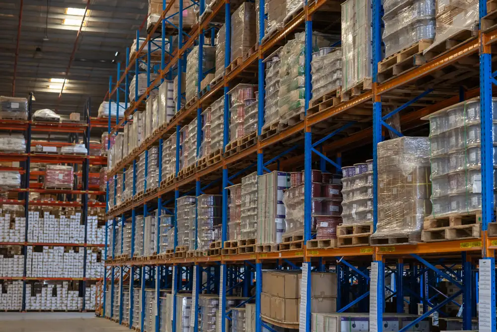 High-bay pallet racking filled with boxed cable stock, photographed for B3 International in a Jebel Ali warehouse.