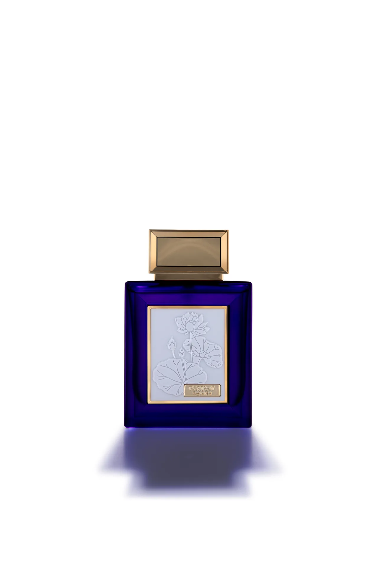 Oud Elite Portrait perfume in a deep blue glass bottle with a gold cap and white embossed lotus label, photographed front-on against white.