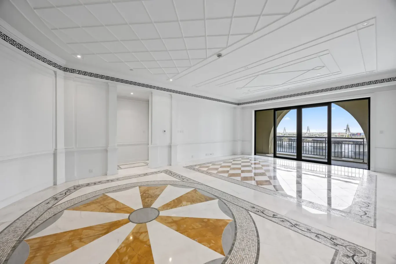 Reception hall with inlaid marble floor and balcony doors in a three-bedroom residence at Palazzo Versace Dubai, Jaddaf Waterfront, photographed for Concierge Auctions.