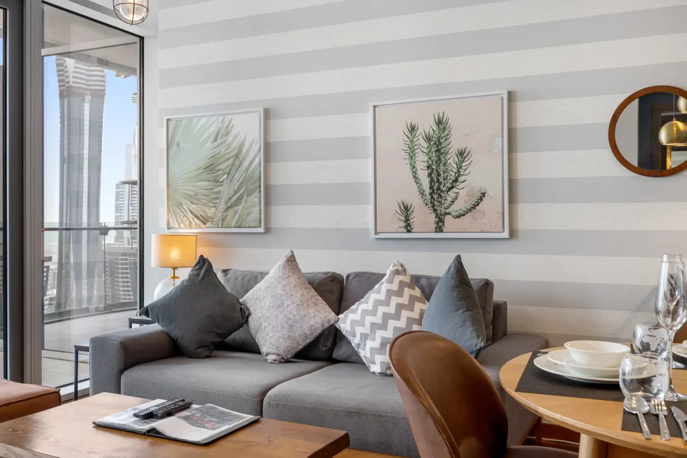 Sofa, coffee table and botanical prints in the living room in a Your Stay Apartments one-bedroom at Burj Daman, DIFC, Dubai.