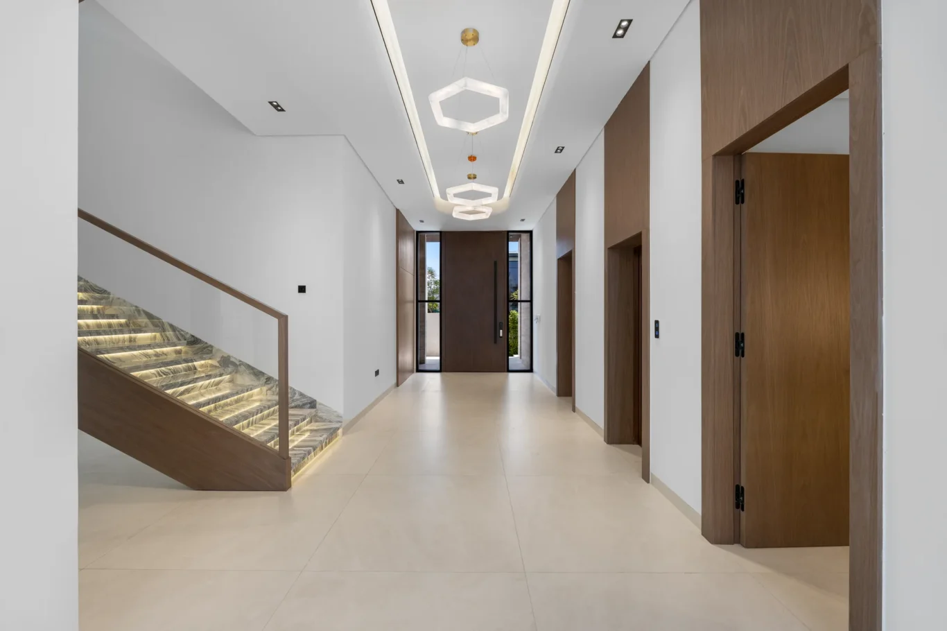 Hallway with the marble staircase and front door, unfurnished five-bedroom villa in Al Furjan, Dubai.