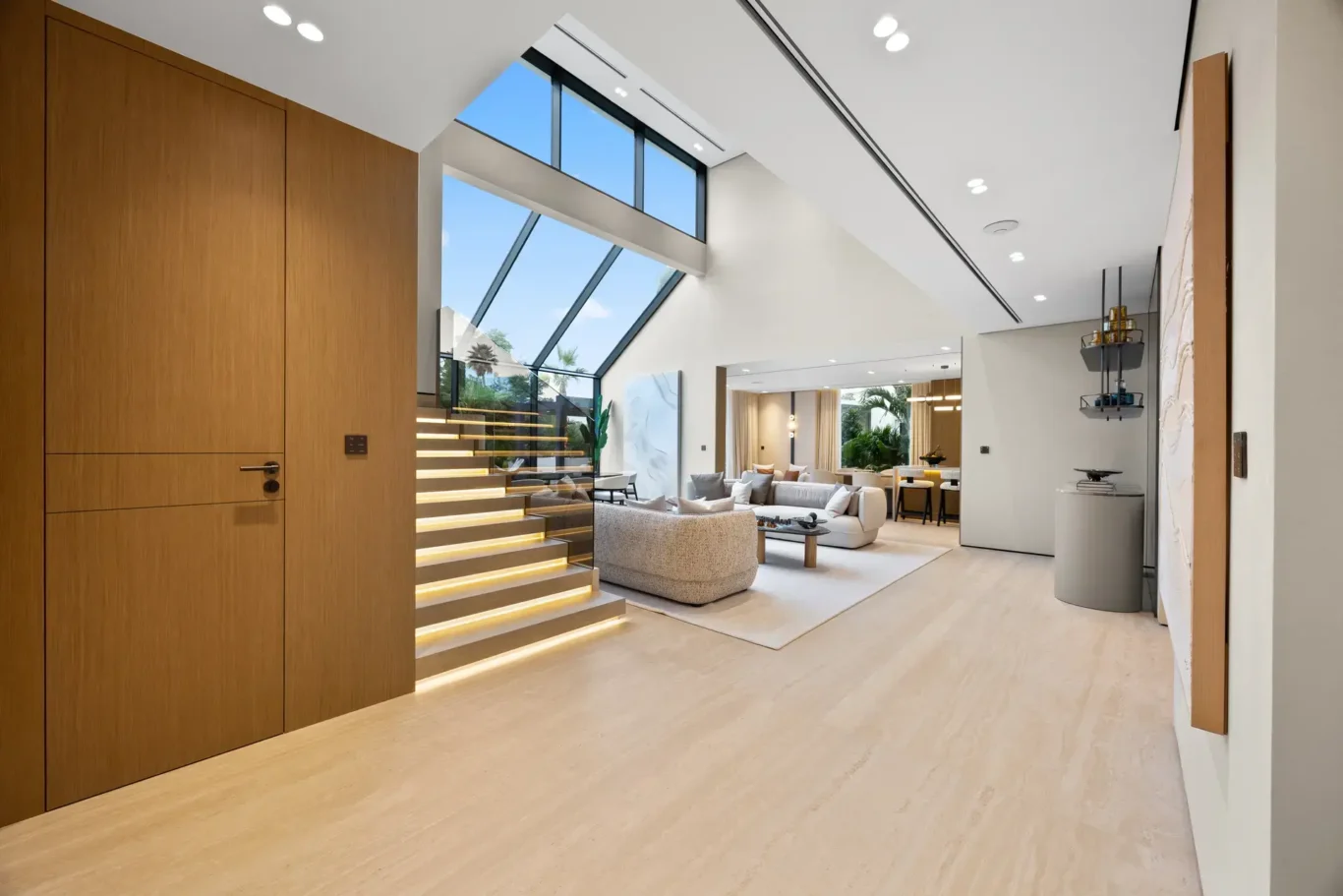 Hallway with lit steps down to the living room and its glass skylight, luxury villa in Jumeirah Islands, Dubai.
