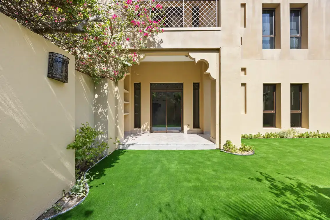Garden lawn facing the apartment terrace doors in an unfurnished two-bedroom garden apartment in Old Town, Downtown Dubai, photographed for ELITE Property Brokerage.