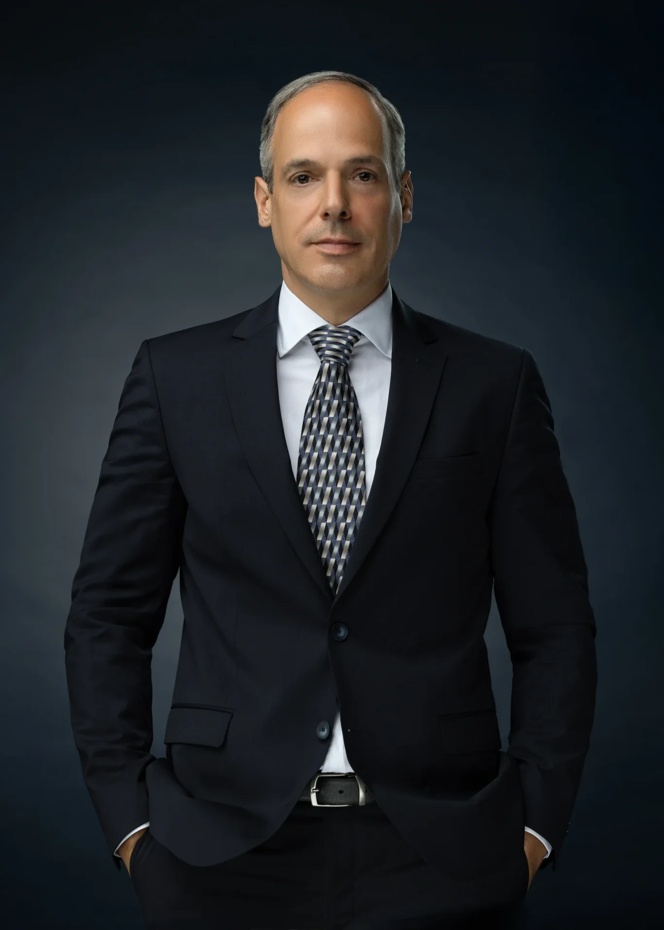 Full standing portrait with one hand in pocket for a company website. Corporate business portrait of a Dubai CEO, photographed at the MRPS studio in Business Bay.