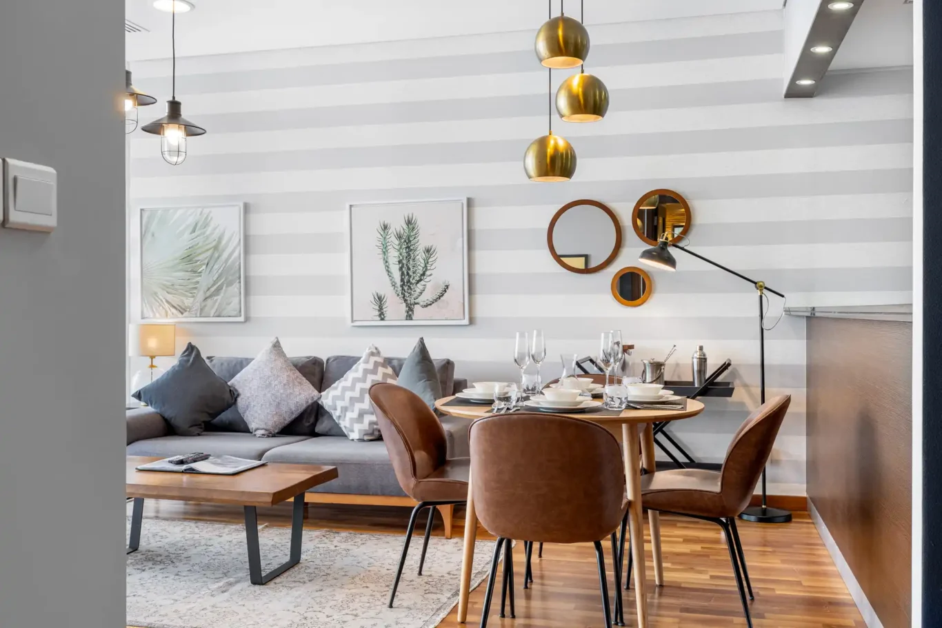 Living area leading to the round dining table in a Your Stay Apartments one-bedroom at Burj Daman, DIFC, Dubai.