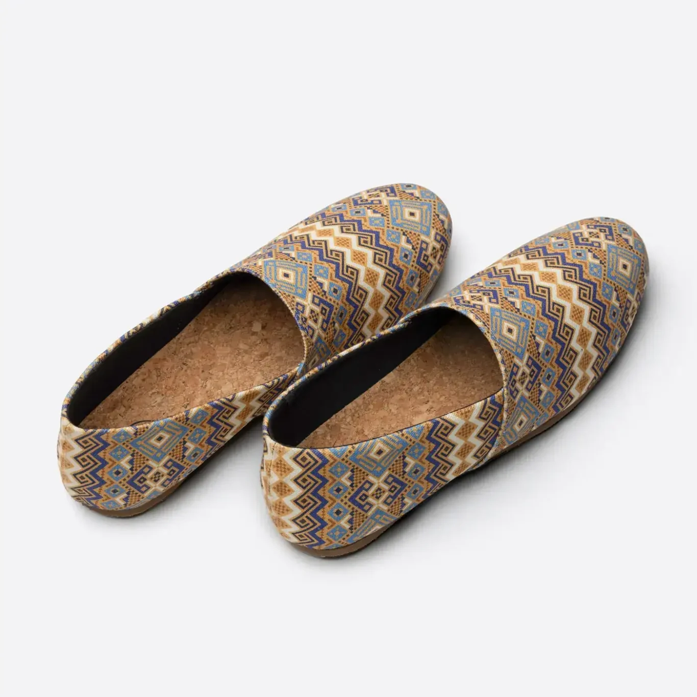 Pair of sand pattern SWAVE slip-ons from behind, showing the cork insoles. E-commerce shoe photography for SWAVE by MRPS in Dubai.