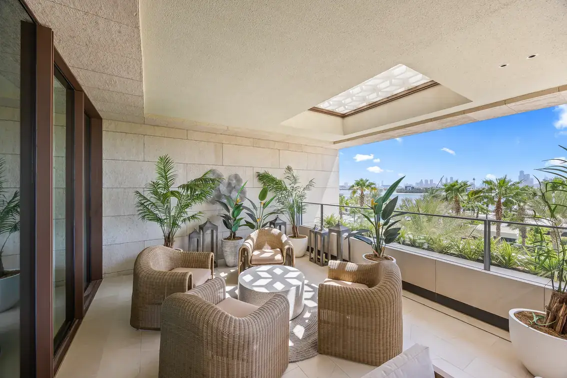 Woven lounge chairs on the terrace under a patterned skylight in a furnished three-bedroom residence at Atlantis The Royal, Palm Jumeirah, photographed for Apex Homes Real Estate.