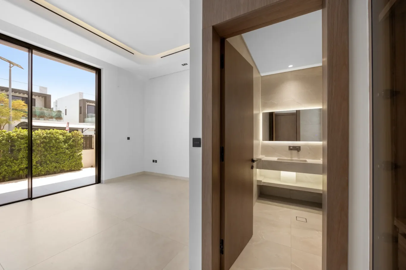 Ground floor room with garden doors and an en-suite bathroom, unfurnished five-bedroom villa in Al Furjan, Dubai.