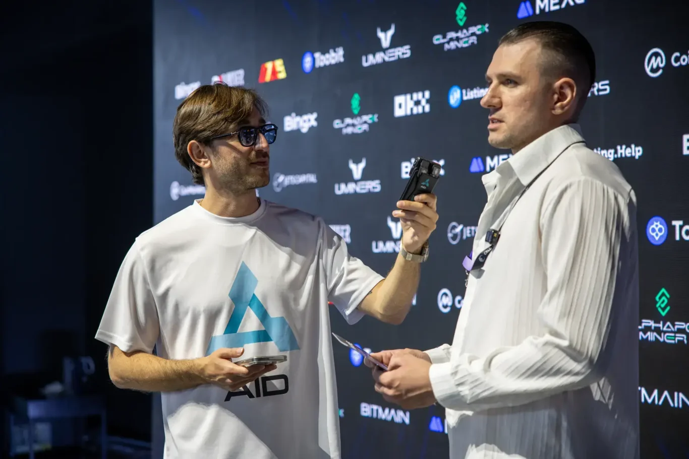 Video interview with an AID representative at the media wall. Event photography by MRPS at Blockchain Life 2025, Festival Arena, Dubai.
