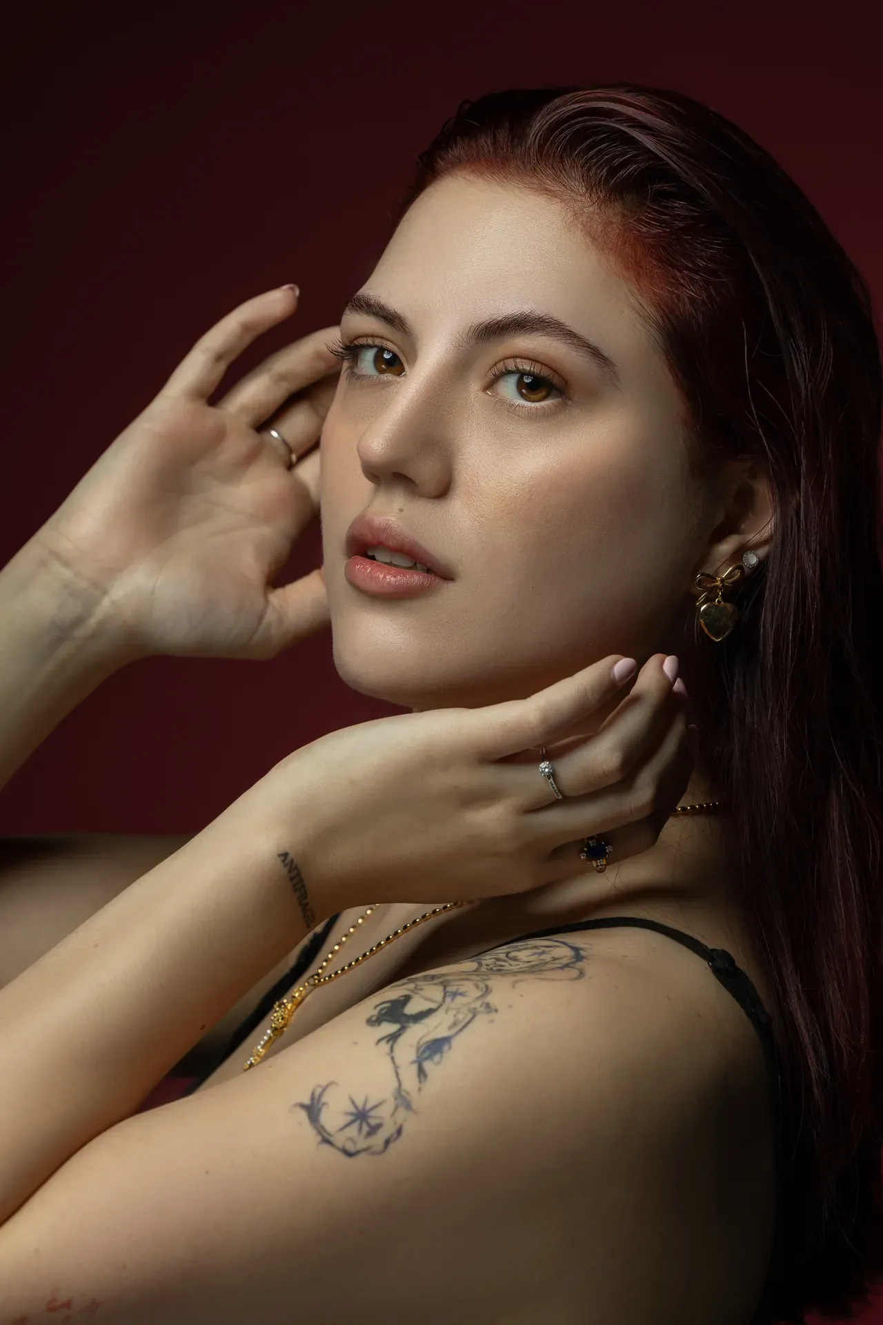 Profile pose with one hand in the hair and a shoulder tattoo. Beauty portrait of model Julian, photographed by Nastaran at the MRPS studio in Dubai.