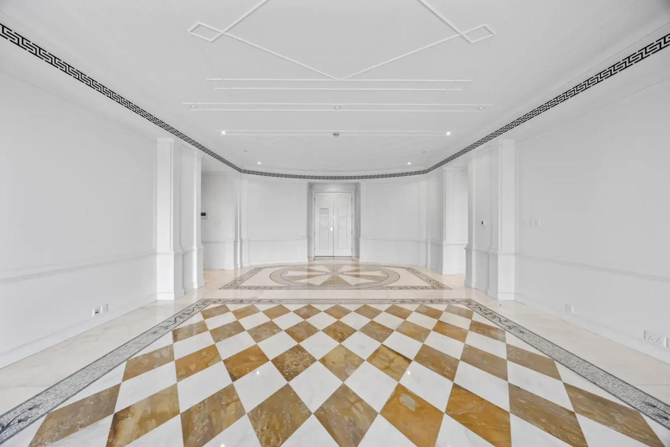 Living and dining area with checkerboard marble floor in a three-bedroom residence at Palazzo Versace Dubai, Jaddaf Waterfront, photographed for Concierge Auctions.