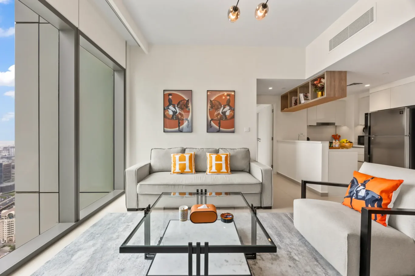 Living room and dining area seen from the entrance of the apartment. Day, twilight and night Airbnb photography by MRPS for Vista Haus Holiday Homes in Downtown Dubai.