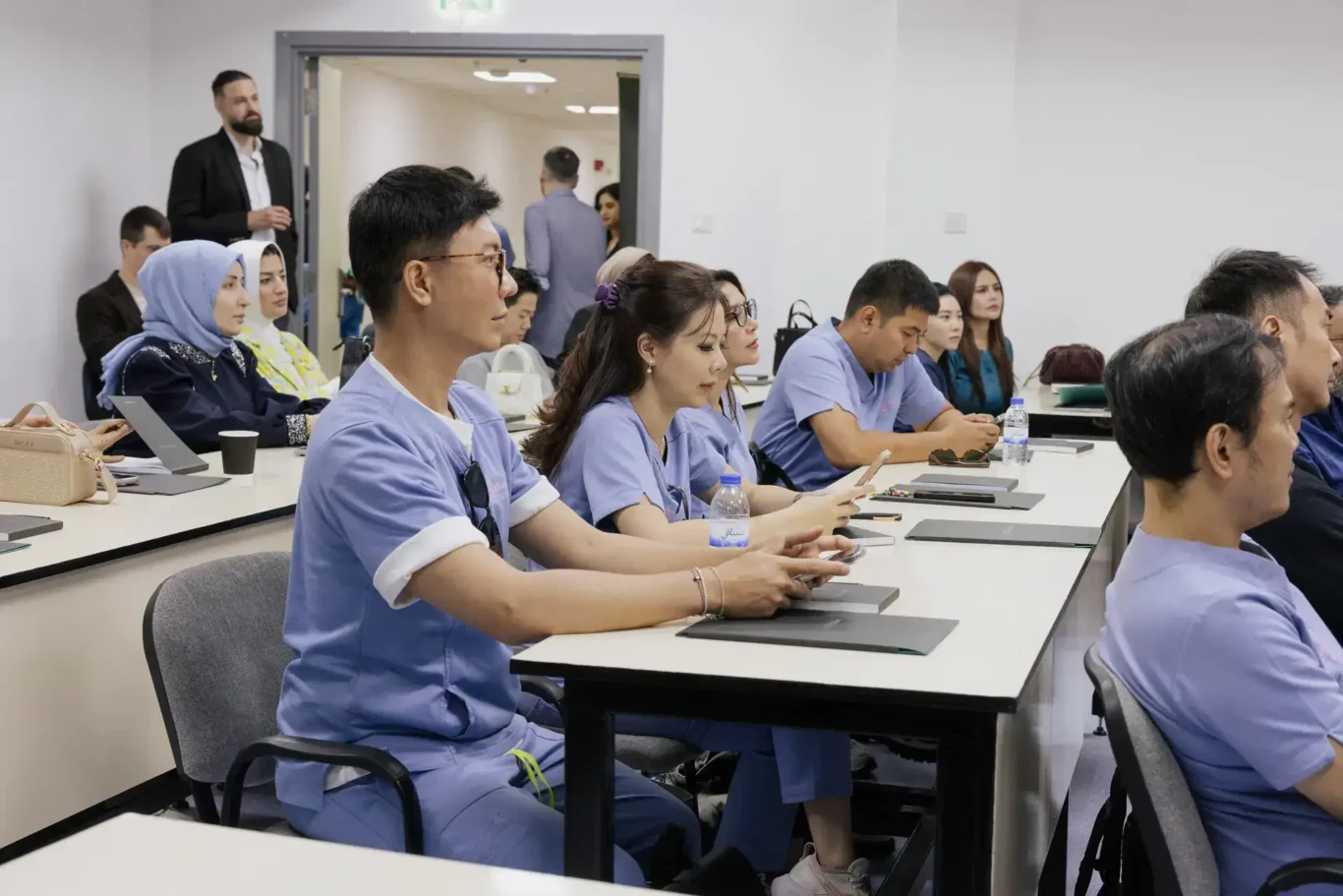 Doctors in scrubs following the theory session. Event photography by MRPS at the Promoitalia Cadaver Lab medical anatomy course in Dubai.