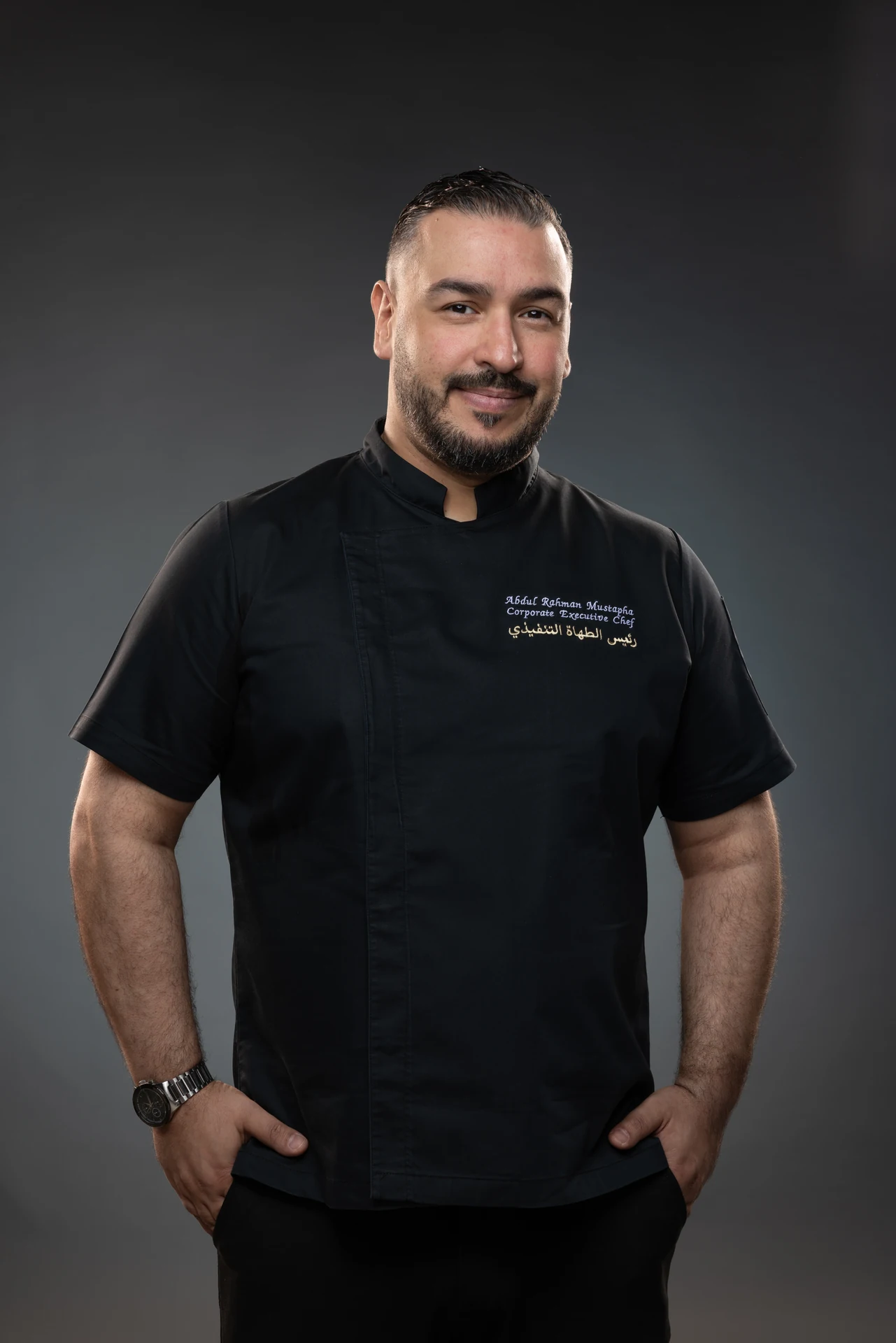 Studio portrait of chef Abdul Rahman Mustapha in a black chef jacket, photographed at MRPS in Dubai.