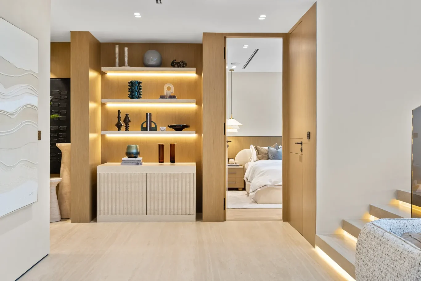 Lit display shelving beside the doorway to a bedroom, luxury villa in Jumeirah Islands, Dubai.