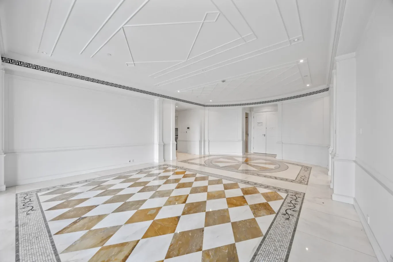 Living area with marble floor and decorative ceiling in a three-bedroom residence at Palazzo Versace Dubai, Jaddaf Waterfront, photographed for Concierge Auctions.