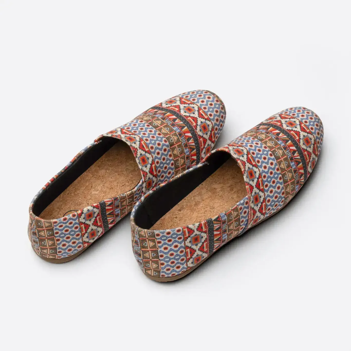 Pair of red pattern SWAVE slip-ons showing the heels and insoles. E-commerce shoe photography for SWAVE by MRPS in Dubai.