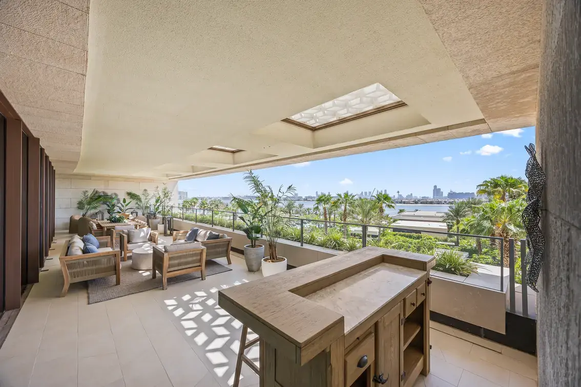 Terrace bar with the Dubai skyline in the distance in a furnished three-bedroom residence at Atlantis The Royal, Palm Jumeirah, photographed for Apex Homes Real Estate.