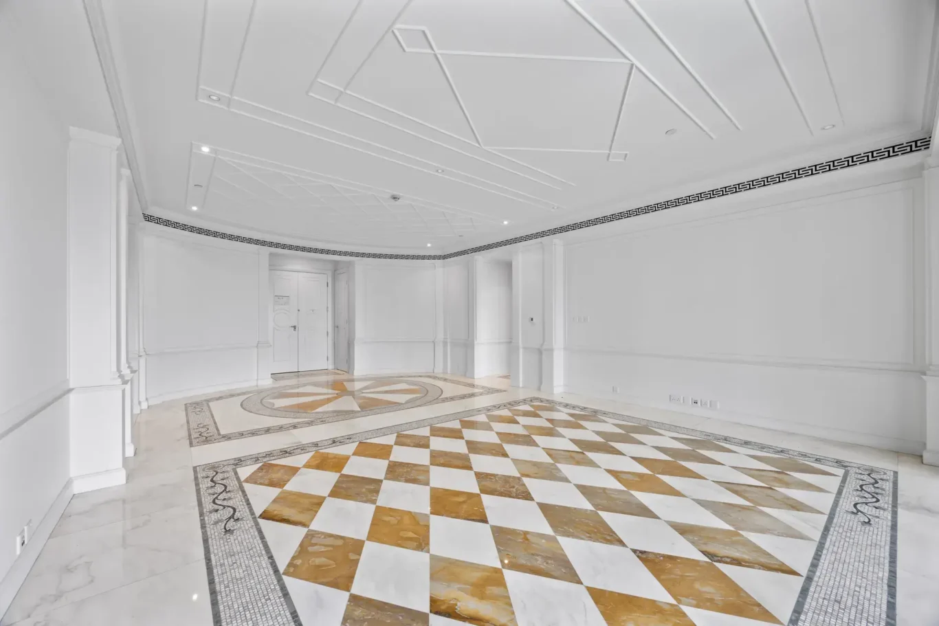 Dining area with checkerboard marble and moulded ceiling in a three-bedroom residence at Palazzo Versace Dubai, Jaddaf Waterfront, photographed for Concierge Auctions.