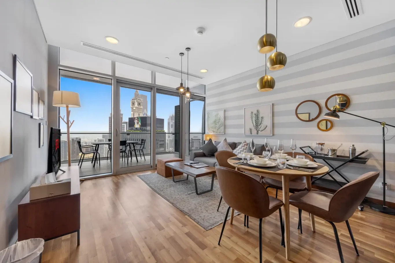 Dining table for four with city view in a Your Stay Apartments one-bedroom at Burj Daman, DIFC, Dubai.