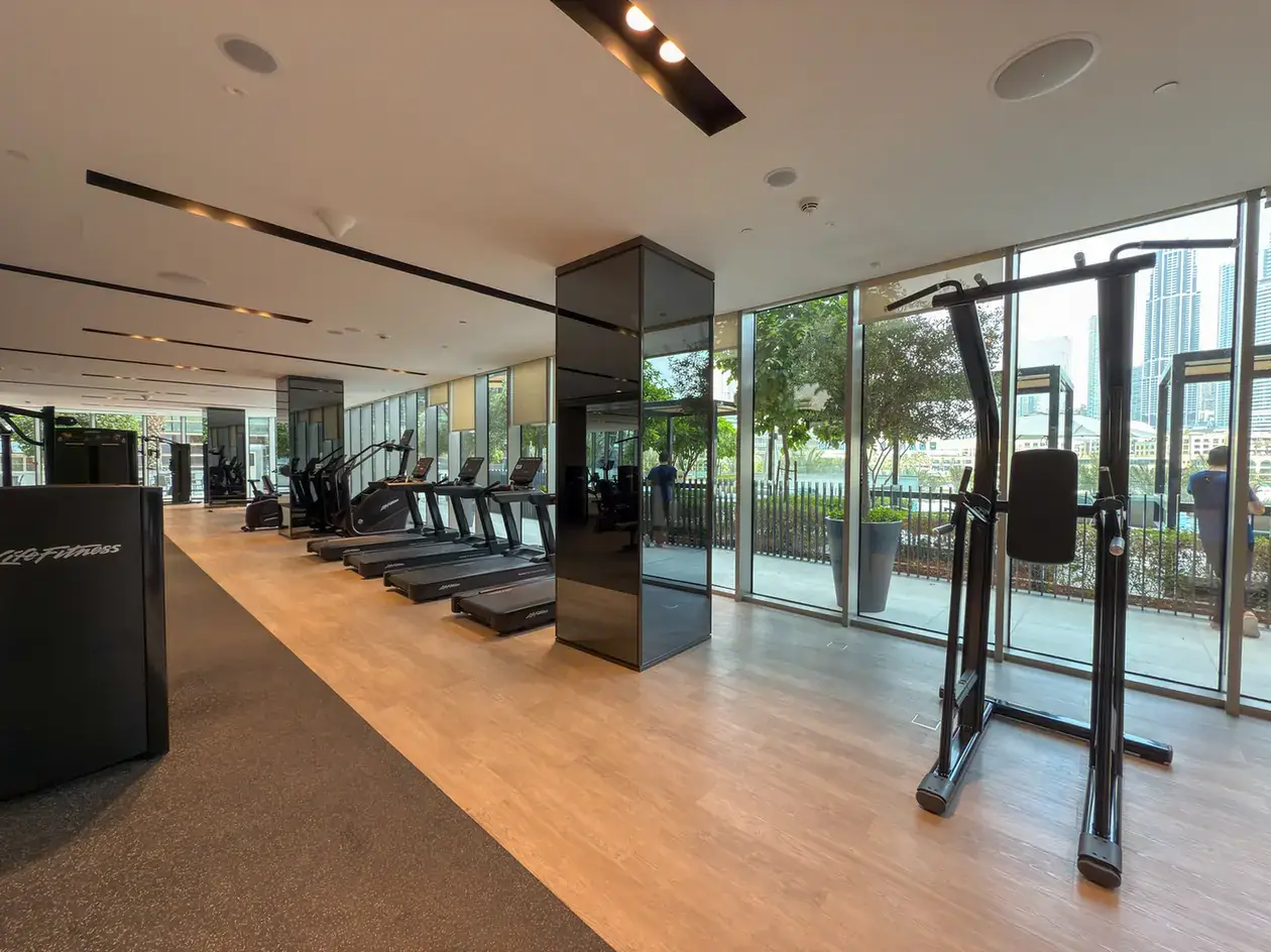 Gym with floor to ceiling windows at Grande Signature, Downtown Dubai, photographed for StayComfy Holiday Homes.