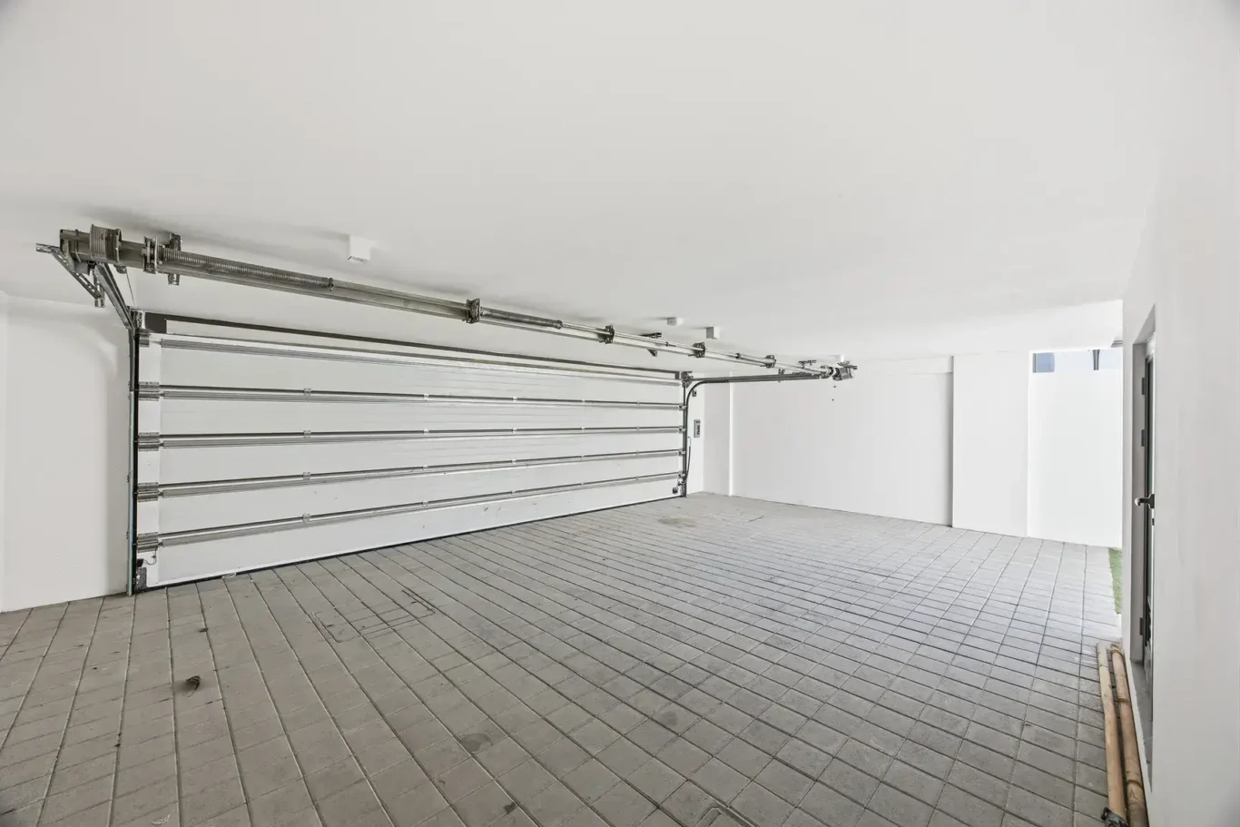 Covered double garage with roller door. Villa photography by MRPS in Dubai for ELITE Property Brokerage.