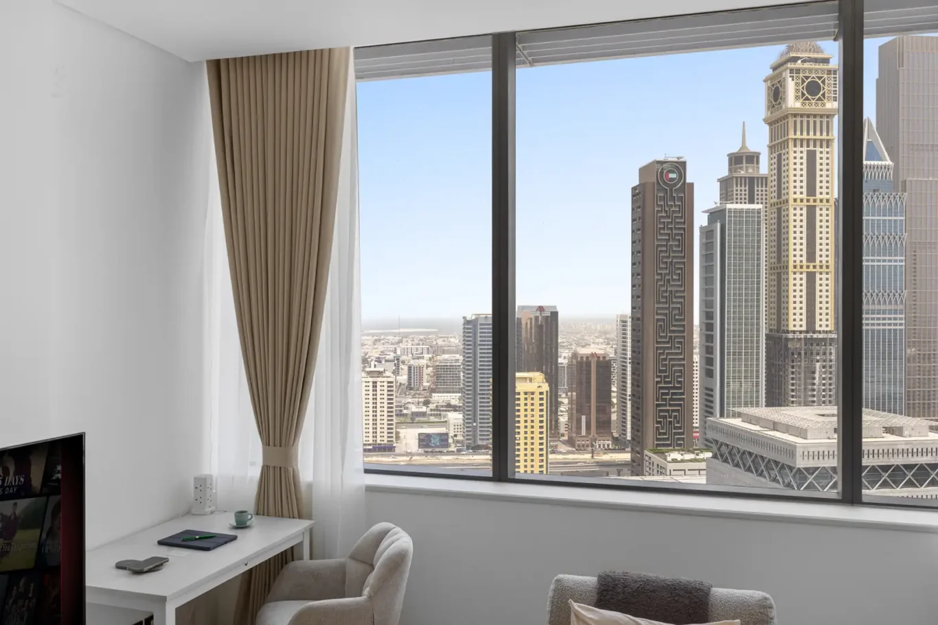 Workspace by the window with city view in a Your Stay Apartments one-bedroom at Sky Gardens, DIFC, Dubai.