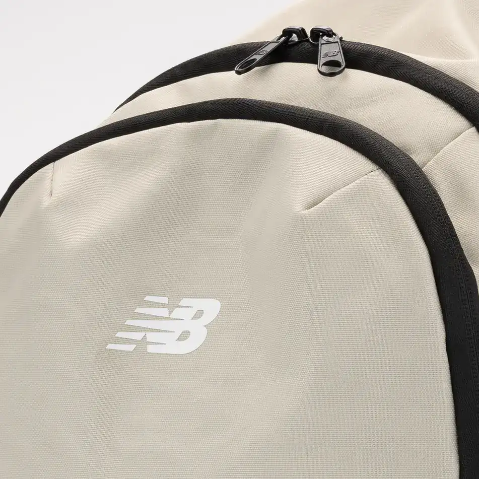 Close-up of the NB logo and zip on the beige New Balance backpack. E-commerce product photography for New Balance by MRPS in Dubai.