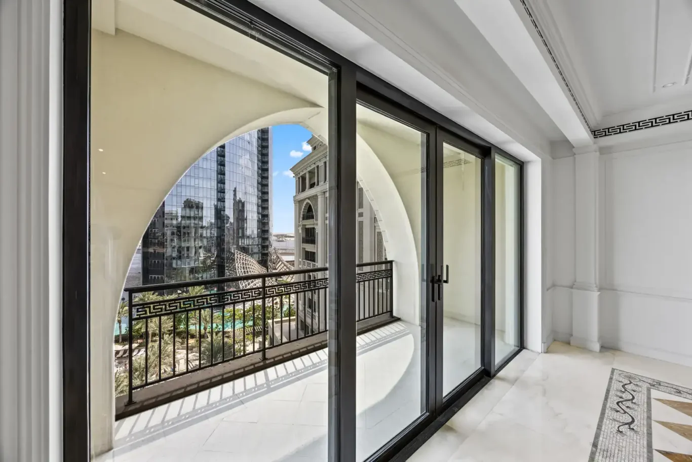 Sliding balcony doors framing the Dubai Creek view in a three-bedroom residence at Palazzo Versace Dubai, Jaddaf Waterfront, photographed for Concierge Auctions.