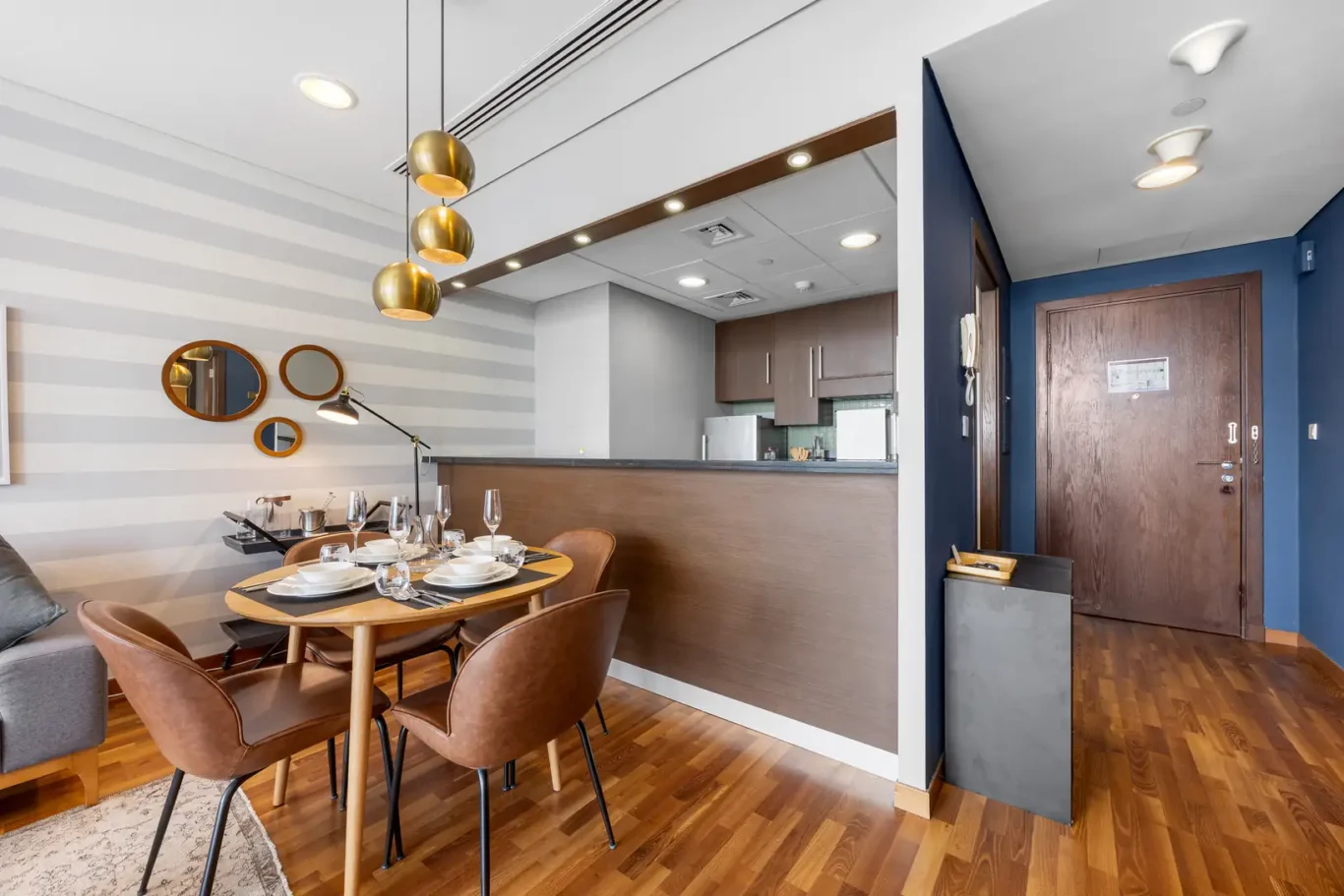 Dining area with the entrance hall behind in a Your Stay Apartments one-bedroom at Burj Daman, DIFC, Dubai.