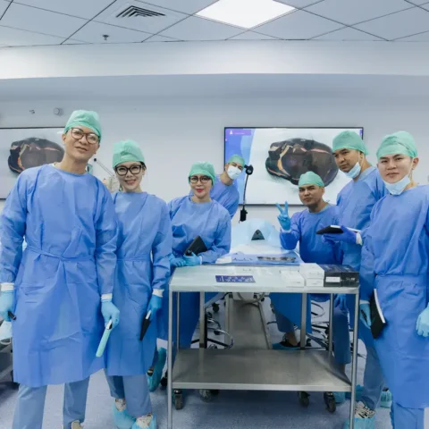 Faculty in surgical gowns and caps in the anatomy lab. Event photography by MRPS at the Promoitalia Cadaver Lab medical anatomy course in Dubai.