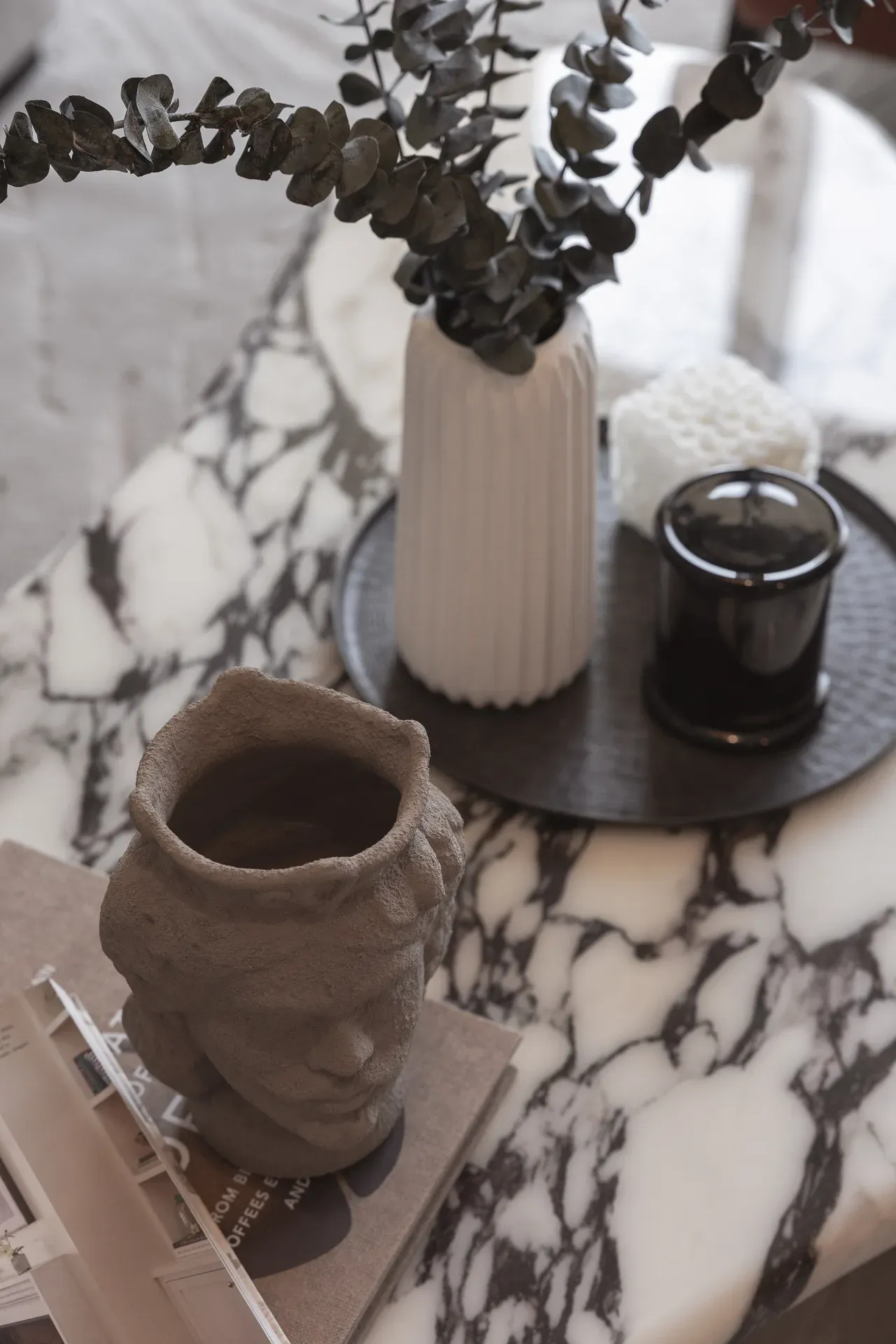 Top view of decor on the white and black marble coffee table. Interior design photography for Aziza Home by MRPS in Dubai.