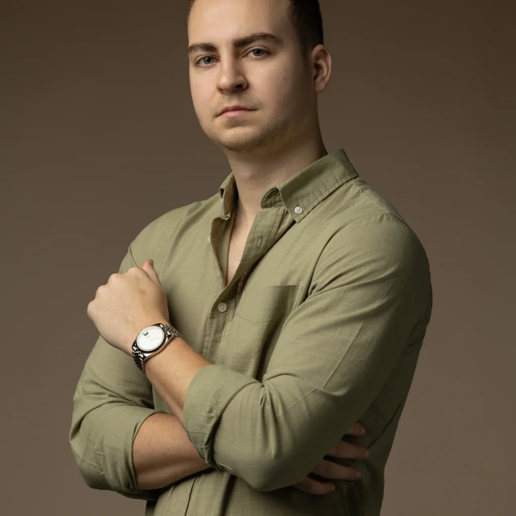 Arms crossed portrait in an olive shirt on a warm beige backdrop. Professional headshot of Tim Ruscica of Tech With Tim, photographed at the MRPS studio in Dubai.