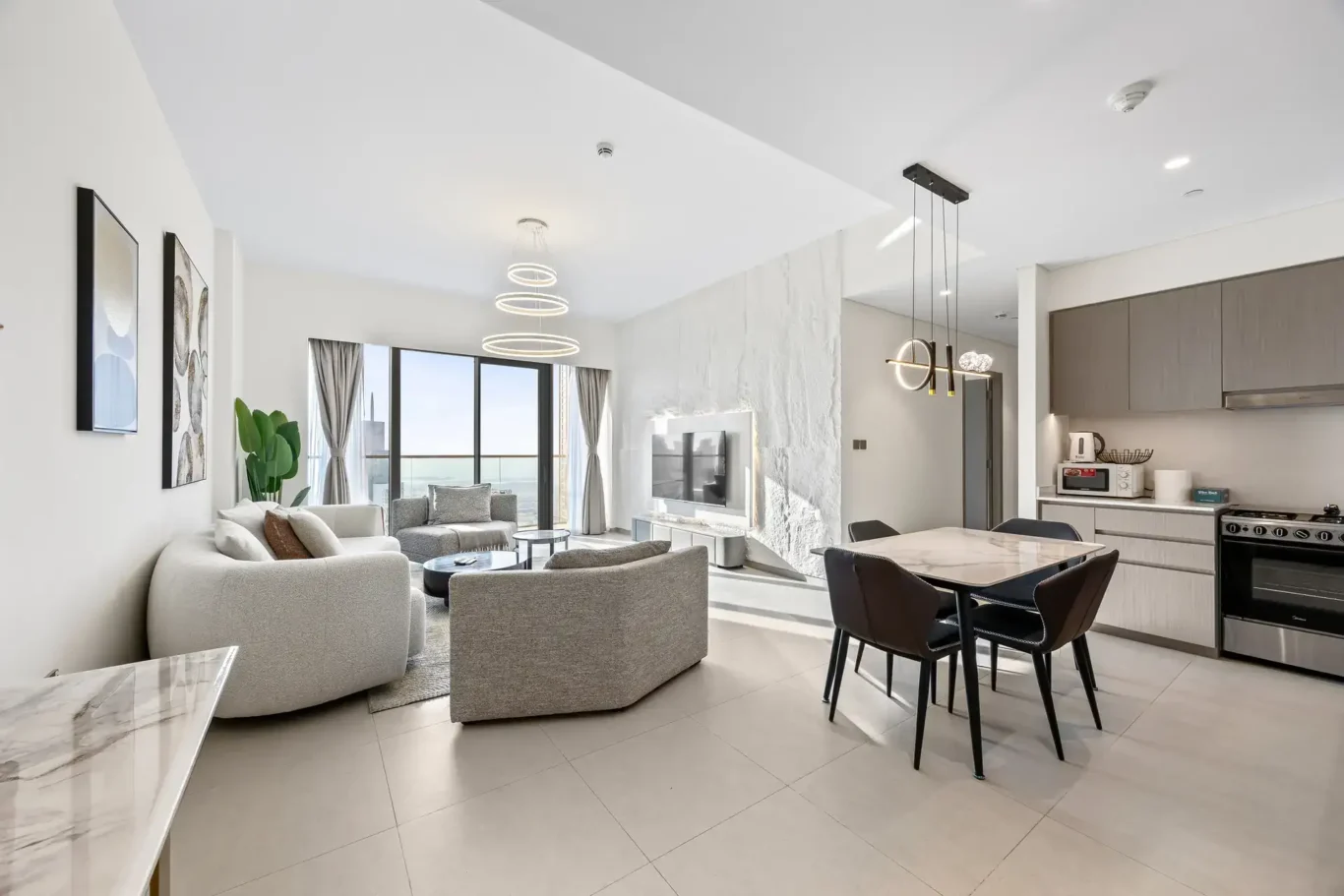 Open plan living room, dining table and kitchen in the two bedroom apartment. Airbnb photography by MRPS for Solea Stay in Dubai.