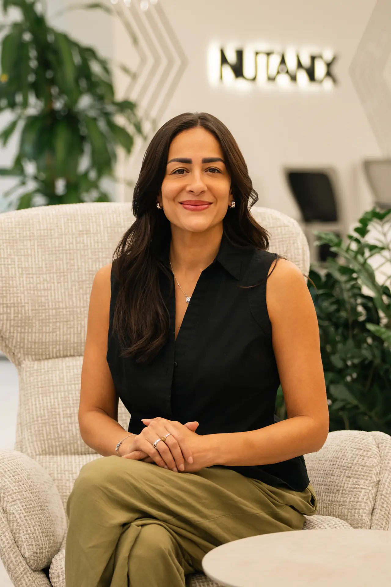 Relaxed seated portrait in the office lounge. On-site corporate headshot at the Nutanix office in Dubai.