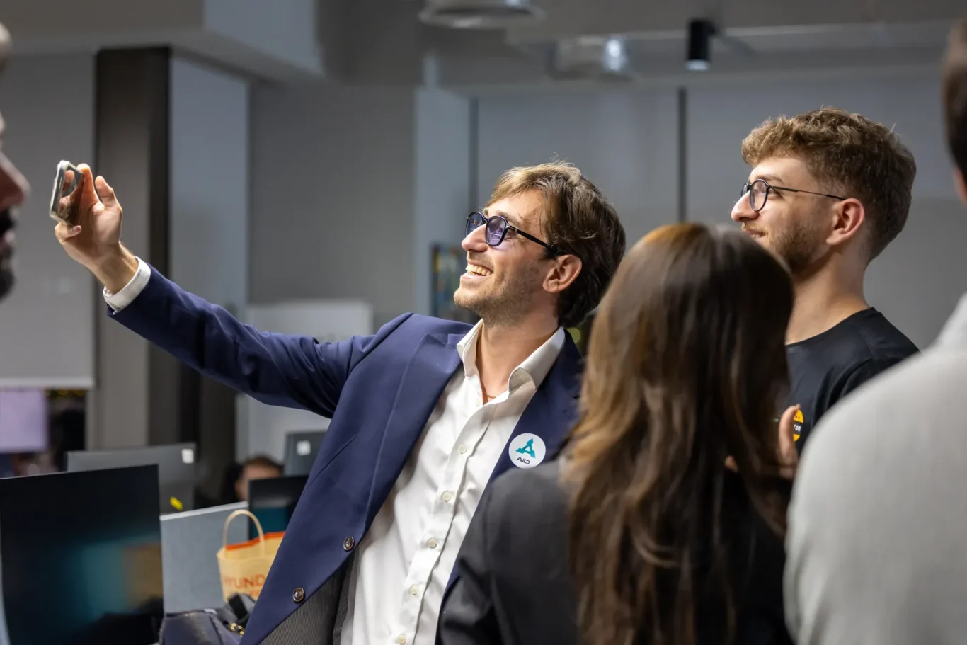 AID speaker taking a selfie with the audience. Event photography by MRPS at Blockchain Life 2025, Festival Arena, Dubai.