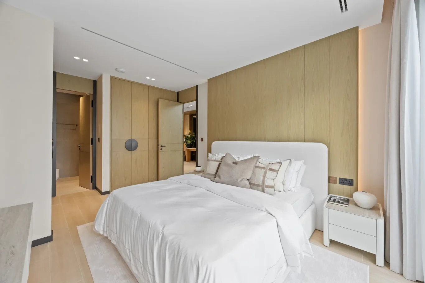 Ground floor bedroom with wood panelling and built-in wardrobes, luxury villa in Jumeirah Islands, Dubai.