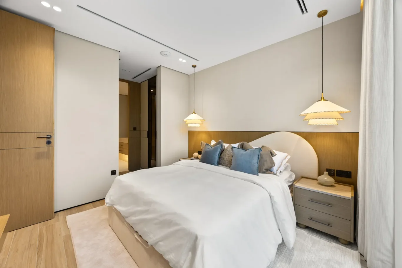 Ground floor bedroom with wood panelling and wardrobes, luxury villa in Jumeirah Islands, Dubai.