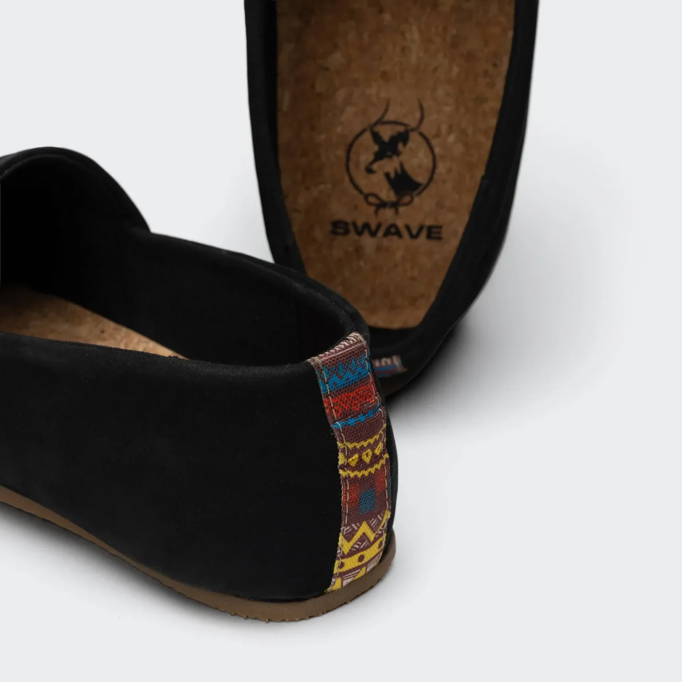Cork insole with the SWAVE logo on a black shoe. E-commerce shoe photography for SWAVE by MRPS in Dubai.