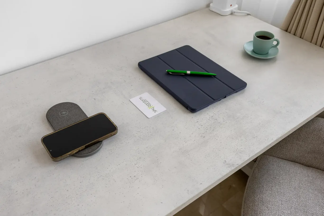 Desk with notebook and wireless charger in a Your Stay Apartments one-bedroom at Sky Gardens, DIFC, Dubai.