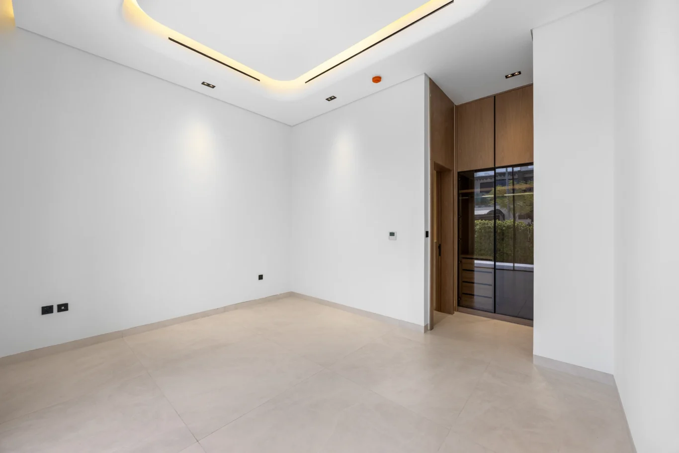 Wide view of the empty ground floor bedroom, unfurnished five-bedroom villa in Al Furjan, Dubai.