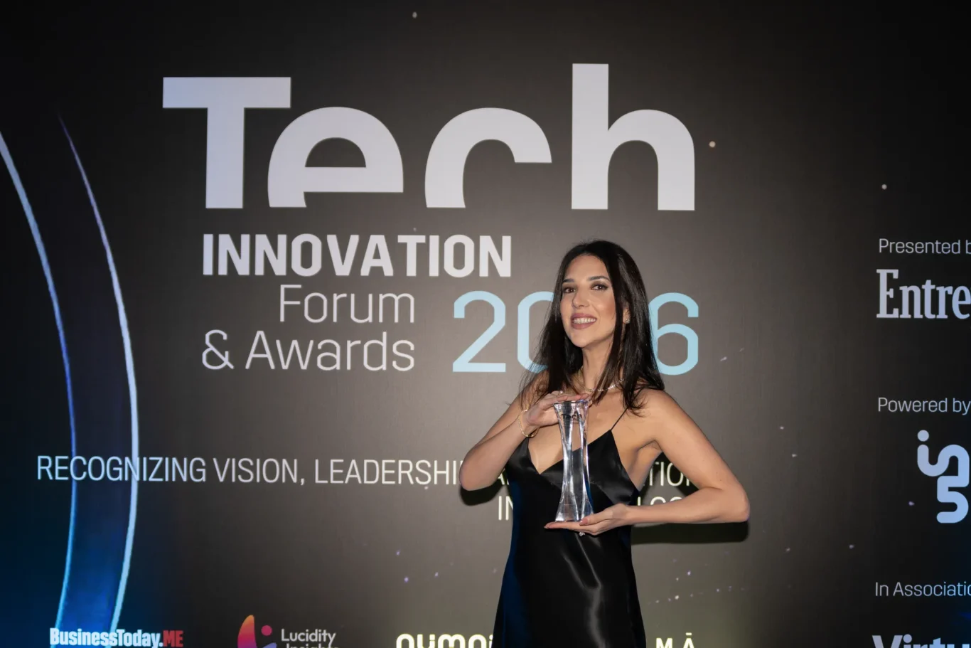 Winner posing with her award in front of the event backdrop. Event photography by MRPS for FundedNext at the Tech Innovation Awards 2026, Al Habtoor Palace, Dubai.