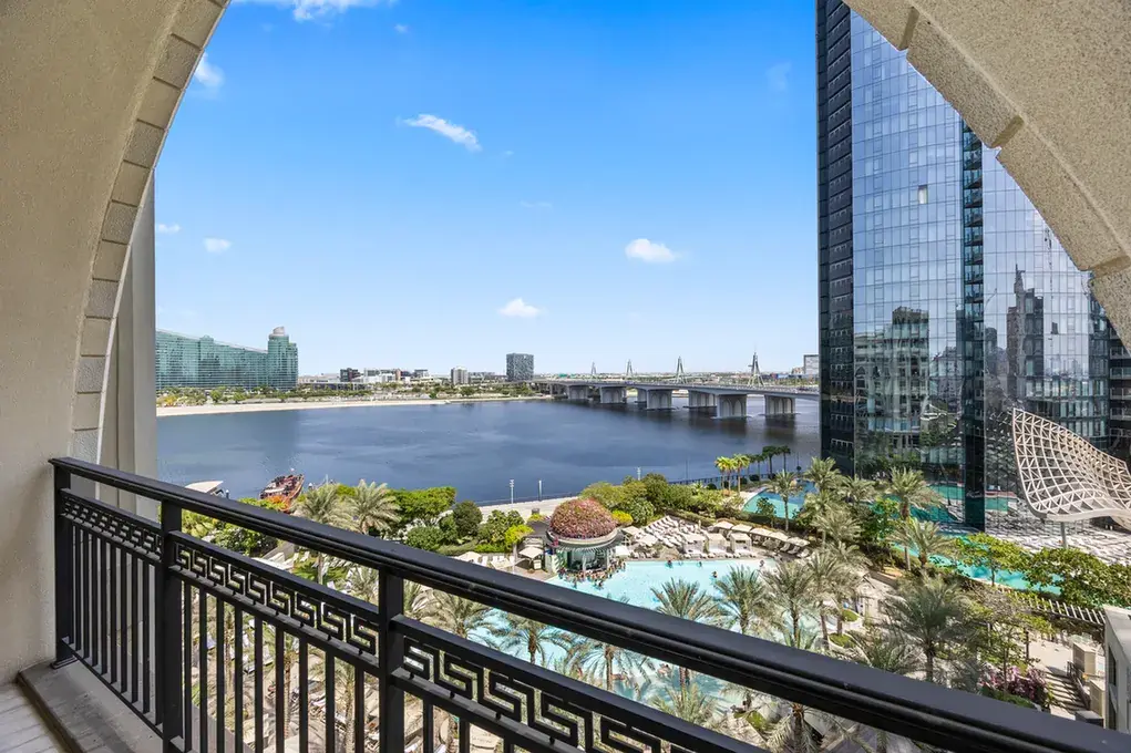 Dubai Creek and the pool gardens seen from the balcony in a three-bedroom residence at Palazzo Versace Dubai, Jaddaf Waterfront, photographed for Concierge Auctions.