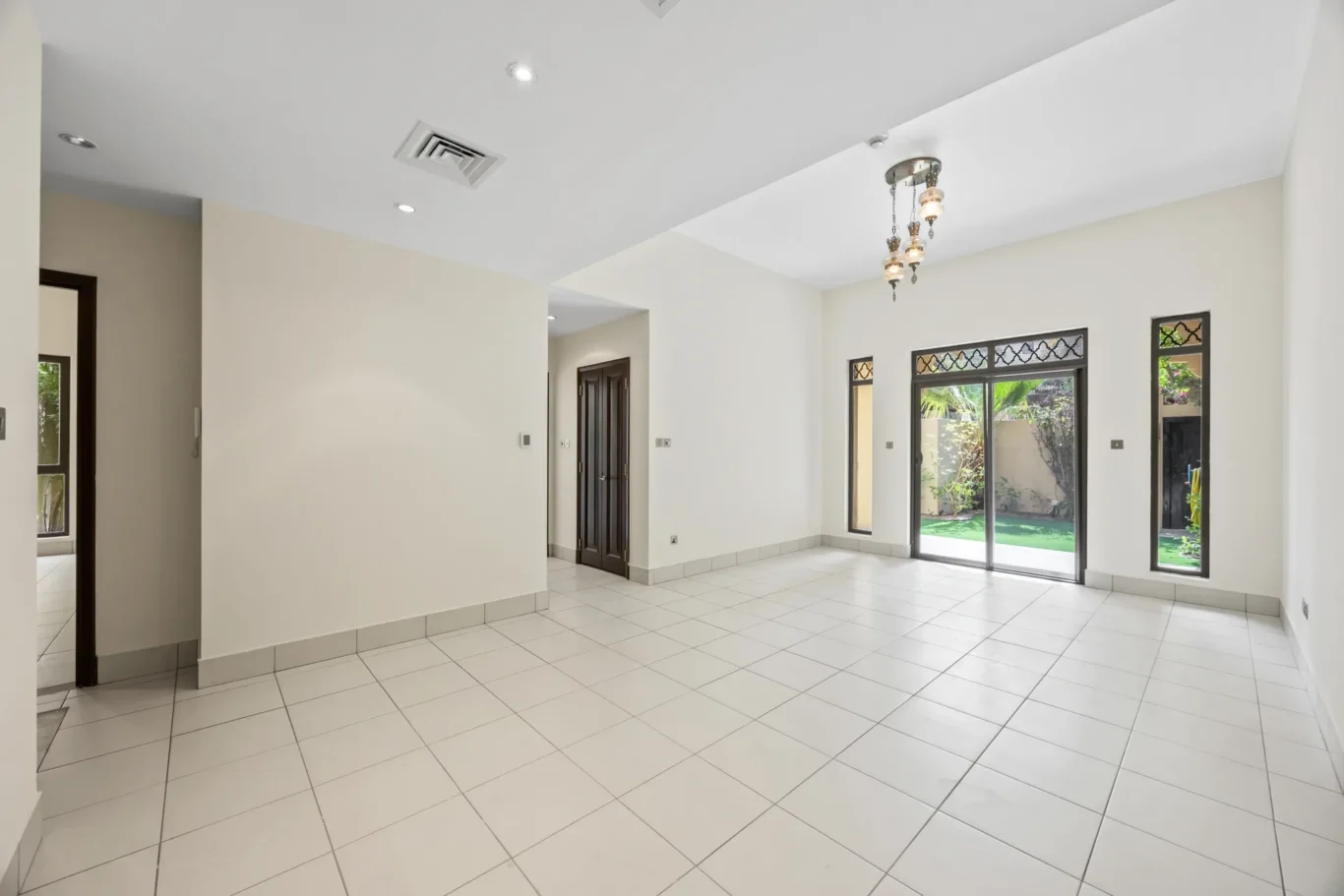 Open living and dining area with lantern light fittings in an unfurnished two-bedroom garden apartment in Old Town, Downtown Dubai, photographed for ELITE Property Brokerage.